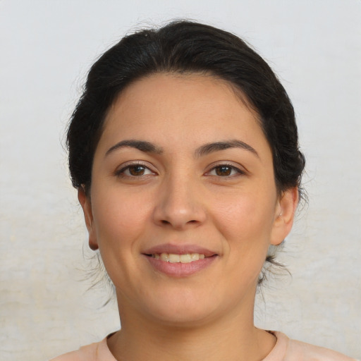 Joyful latino young-adult female with medium  brown hair and brown eyes