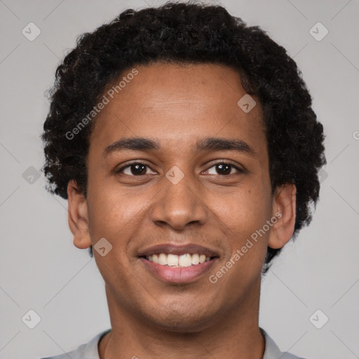 Joyful black young-adult male with short  brown hair and brown eyes