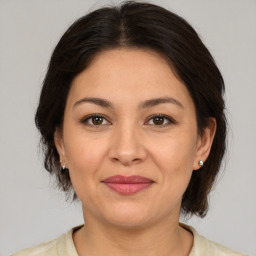 Joyful white adult female with medium  brown hair and brown eyes