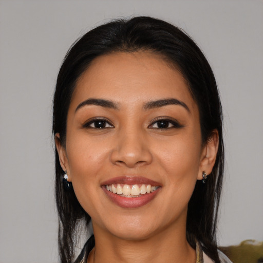 Joyful latino young-adult female with long  black hair and brown eyes