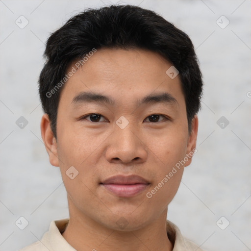 Joyful asian young-adult male with short  black hair and brown eyes