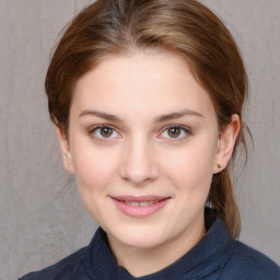 Joyful white young-adult female with medium  brown hair and blue eyes