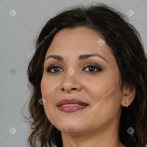 Joyful white adult female with long  brown hair and brown eyes