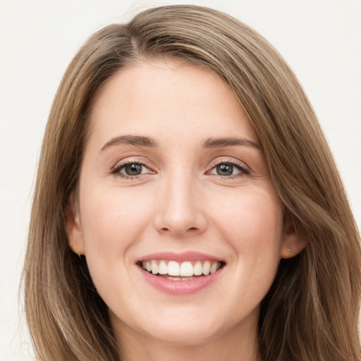 Joyful white young-adult female with long  brown hair and green eyes