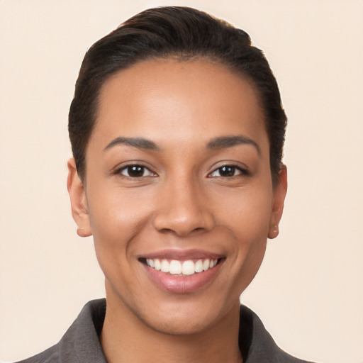 Joyful latino young-adult female with short  black hair and brown eyes