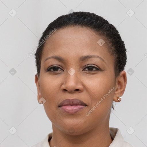 Joyful black young-adult female with short  brown hair and brown eyes