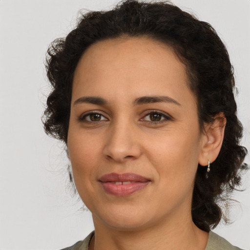 Joyful latino young-adult female with medium  brown hair and brown eyes