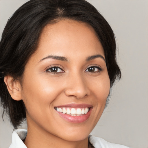 Joyful latino young-adult female with medium  brown hair and brown eyes