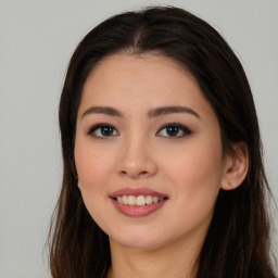 Joyful asian young-adult female with long  brown hair and brown eyes