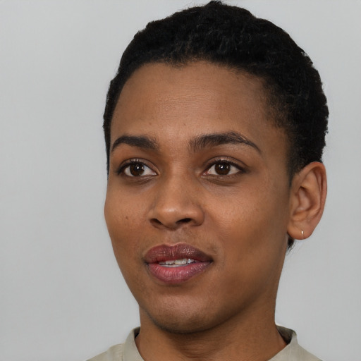 Joyful black young-adult female with short  black hair and brown eyes