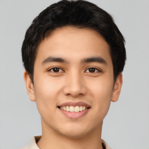 Joyful asian young-adult male with short  black hair and brown eyes