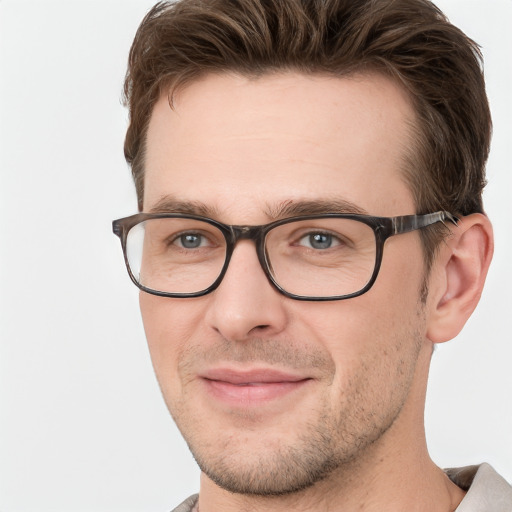 Joyful white adult male with short  brown hair and grey eyes