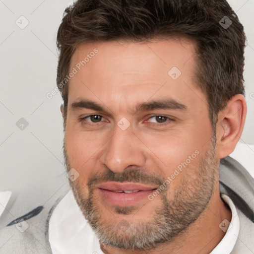 Joyful white adult male with short  brown hair and brown eyes