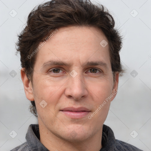 Joyful white adult male with short  brown hair and grey eyes