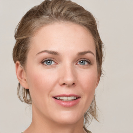 Joyful white young-adult female with medium  brown hair and blue eyes