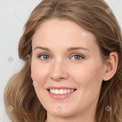 Joyful white young-adult female with long  brown hair and blue eyes