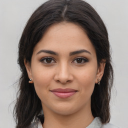 Joyful latino young-adult female with medium  brown hair and brown eyes