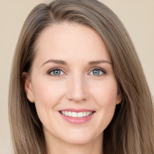 Joyful white young-adult female with long  brown hair and grey eyes