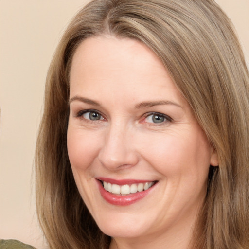 Joyful white adult female with long  brown hair and brown eyes