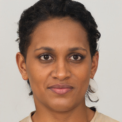 Joyful black young-adult female with short  brown hair and brown eyes