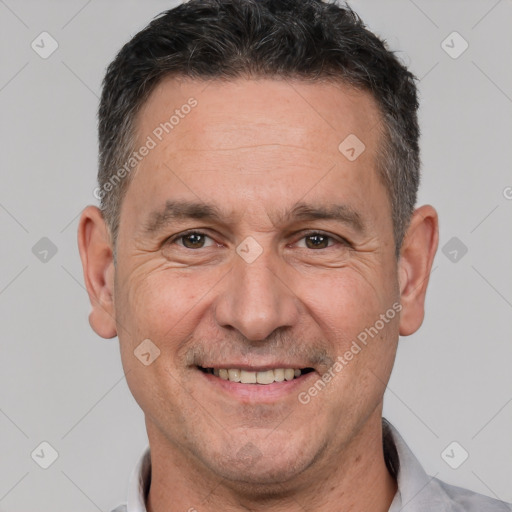 Joyful white adult male with short  brown hair and brown eyes