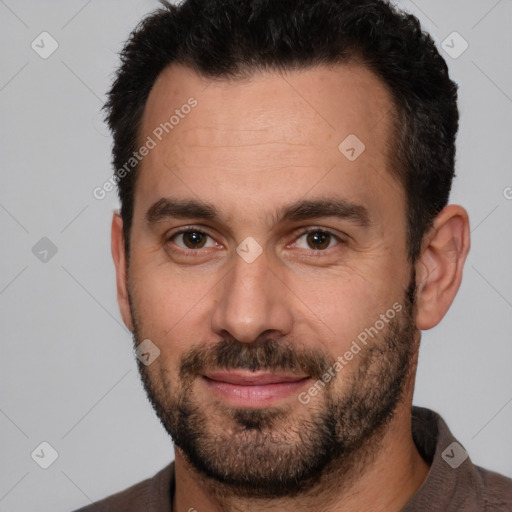 Joyful white adult male with short  brown hair and brown eyes