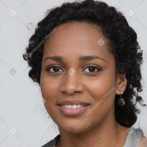 Joyful black young-adult female with long  black hair and brown eyes