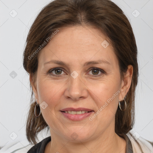 Joyful white adult female with medium  brown hair and brown eyes