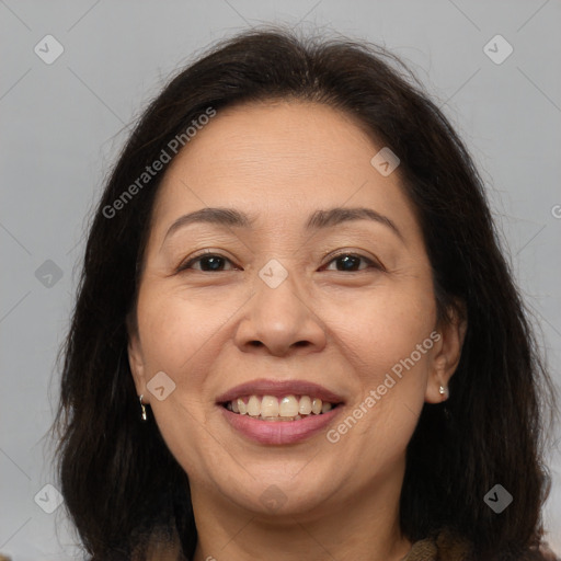 Joyful white adult female with long  brown hair and brown eyes