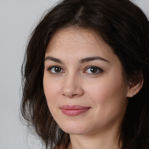 Joyful white young-adult female with long  brown hair and brown eyes