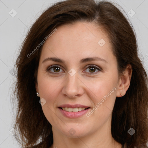 Joyful white adult female with long  brown hair and brown eyes