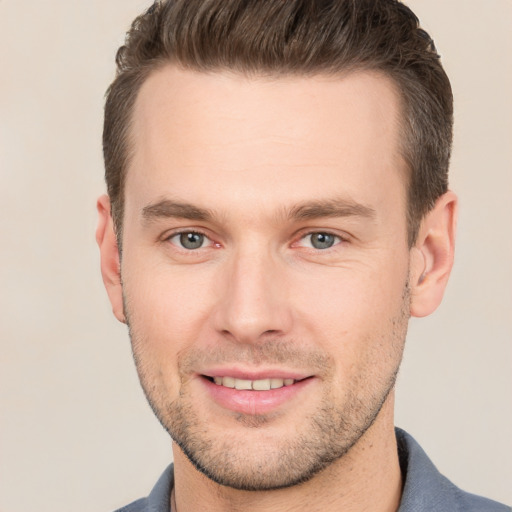 Joyful white young-adult male with short  brown hair and brown eyes