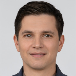 Joyful white young-adult male with short  brown hair and brown eyes