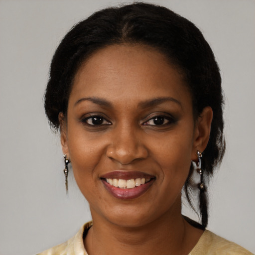Joyful black young-adult female with medium  brown hair and brown eyes
