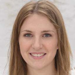 Joyful white young-adult female with long  brown hair and green eyes