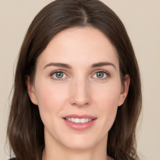 Joyful white young-adult female with long  brown hair and brown eyes