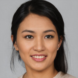 Joyful asian young-adult female with medium  black hair and brown eyes