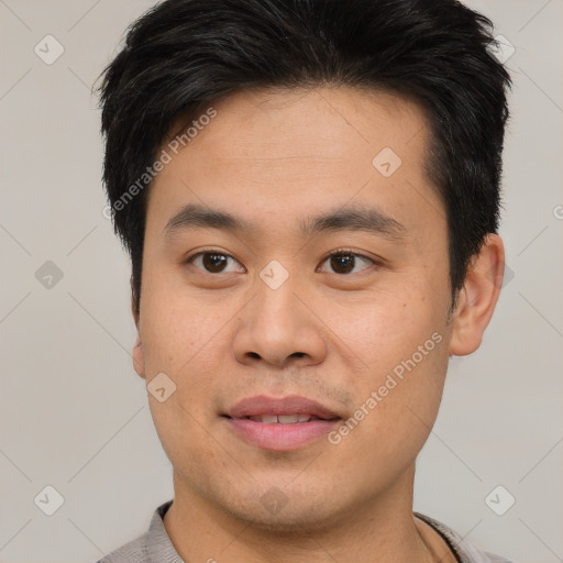 Joyful asian young-adult male with short  brown hair and brown eyes