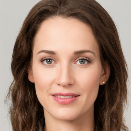 Joyful white young-adult female with long  brown hair and green eyes