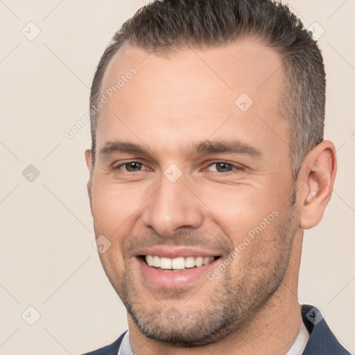 Joyful white young-adult male with short  brown hair and brown eyes