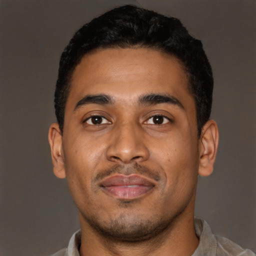 Joyful latino young-adult male with short  brown hair and brown eyes