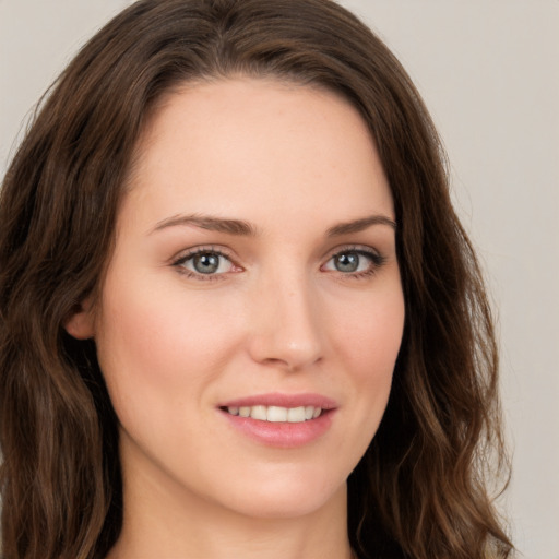 Joyful white young-adult female with long  brown hair and green eyes