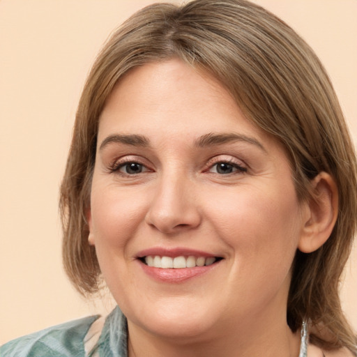 Joyful white young-adult female with medium  brown hair and grey eyes