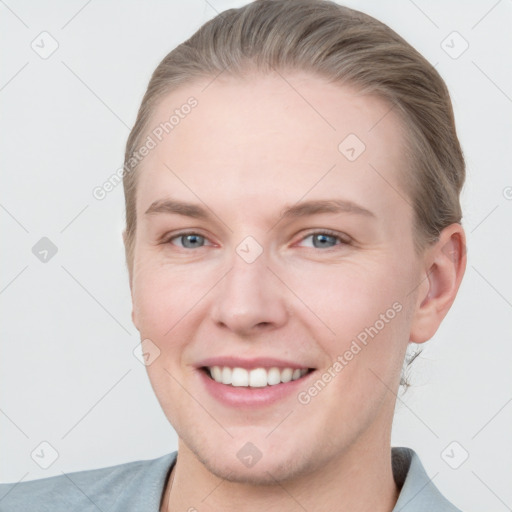 Joyful white young-adult female with short  brown hair and grey eyes