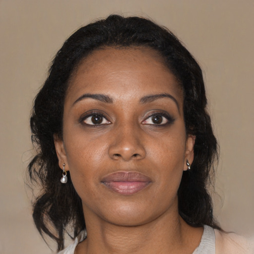 Joyful black young-adult female with medium  brown hair and brown eyes