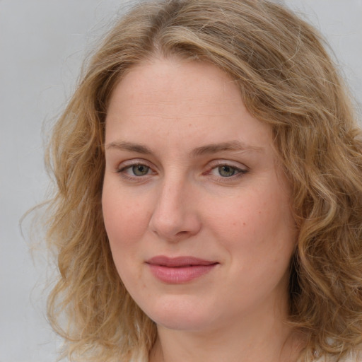 Joyful white young-adult female with medium  brown hair and blue eyes