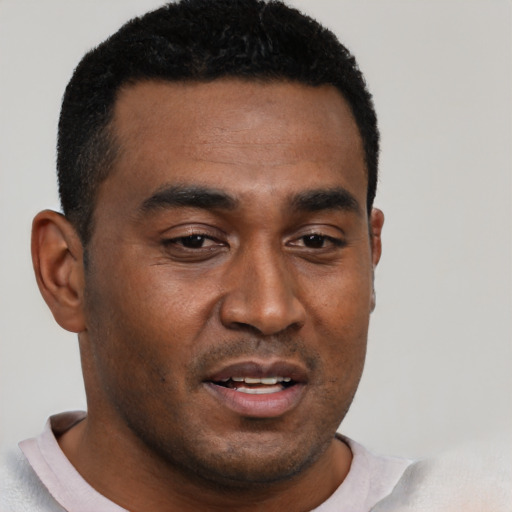 Joyful black young-adult male with short  black hair and brown eyes