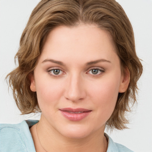 Joyful white young-adult female with medium  brown hair and blue eyes