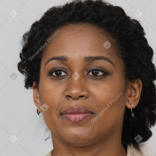 Joyful black adult female with short  brown hair and brown eyes