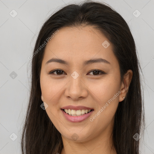 Joyful latino young-adult female with long  brown hair and brown eyes